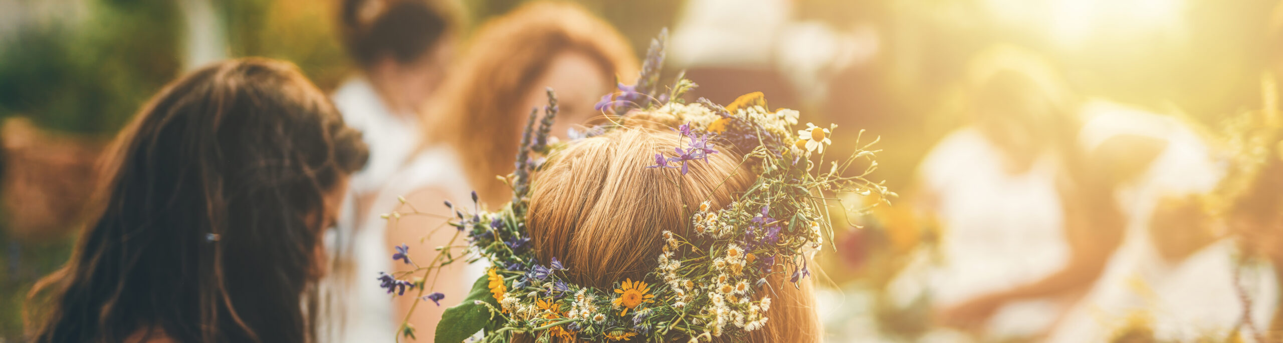 View of women making wreaths with beautiful flowers.